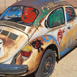 Paint-a-bug - VW Bug Graffiti - Spray Paint VW Bug - Selfie Spot - Route 66 - Winslow Arizona - Meteor City - Dino Drive-Thru - Volkswagon Bug Spray Painting Graffiti